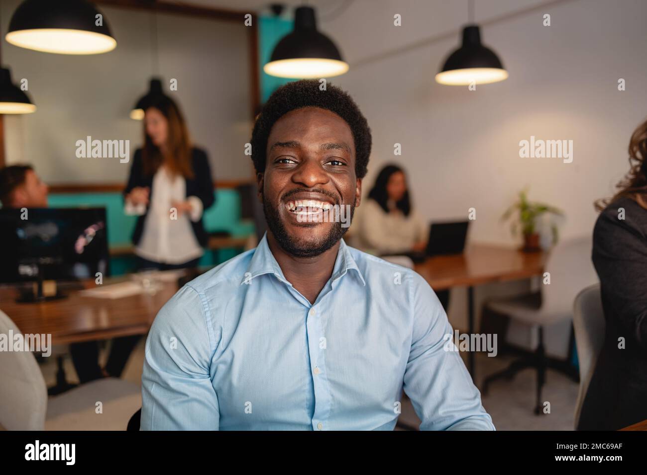 Happy African man in coworking creative space Stock Photo