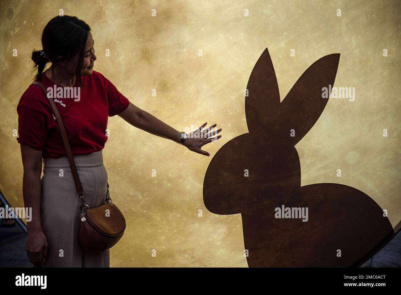 Bangkok, Thailand. 21st Jan, 2023. A woman poses for a picture next to a light sculpture in rabbit theme during the Lunar new year celebration at Bangkok's Chinatown. Credit: SOPA Images Limited/Alamy Live News Stock Photo