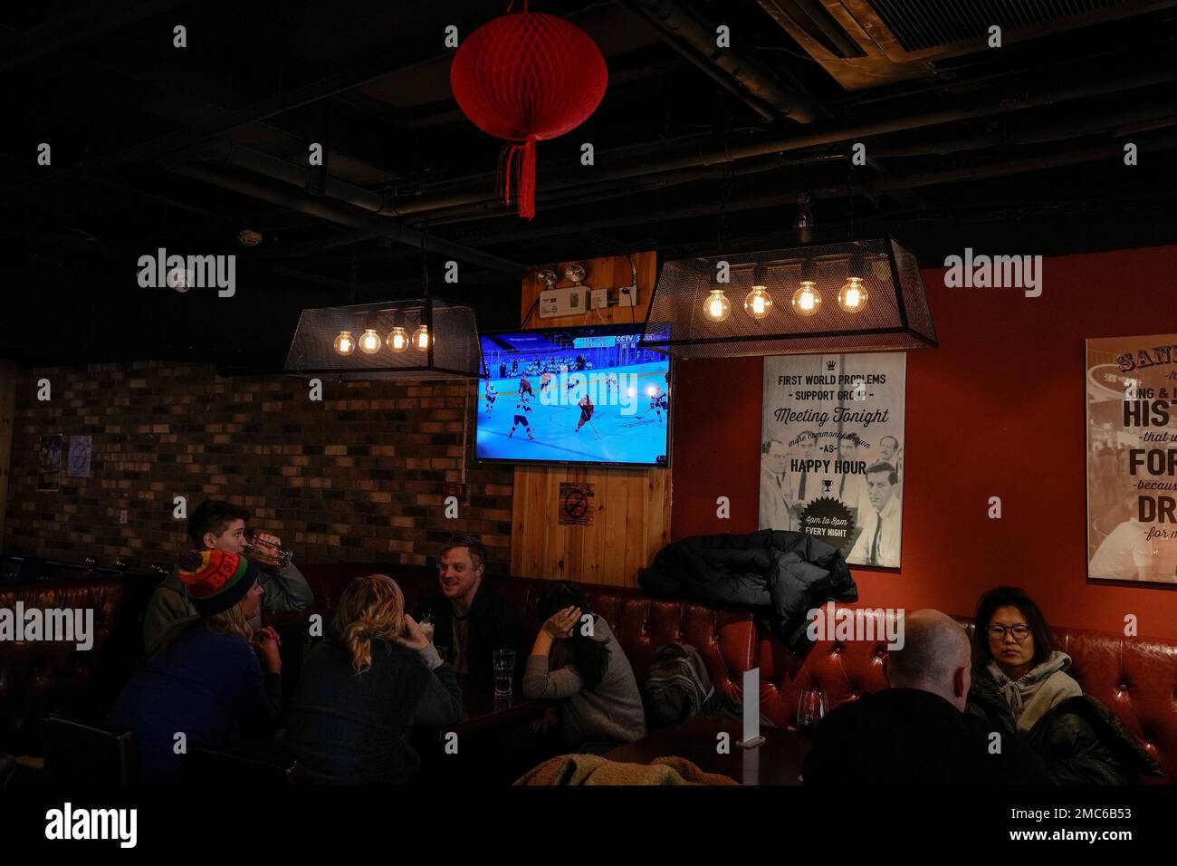 A TV shows a live broadcast of the womens gold medal ice hockey game between United States and Canada during the 2022 Winter Olympics, at a restaurant in Beijing, Thursday, Feb