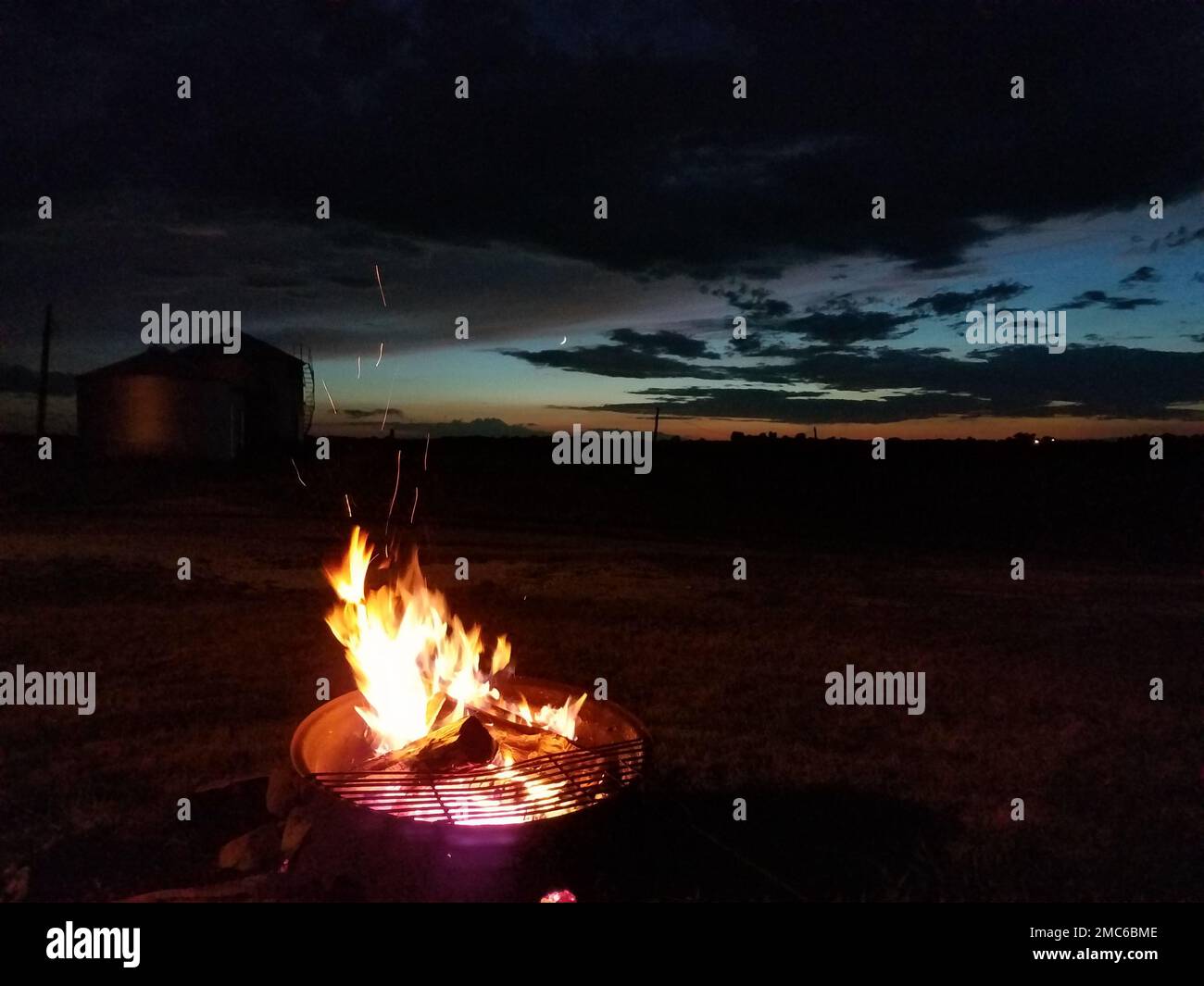 A view of a bonfire in the field at night Stock Photo - Alamy