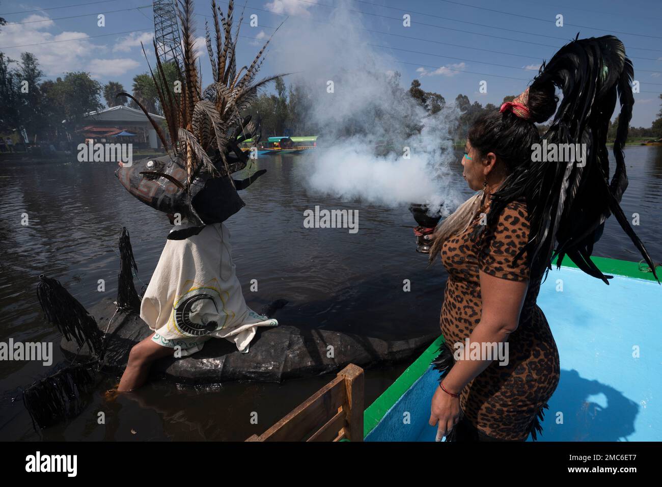 Manuel Rodriguez sits atop a canoe shaped in the form of salamander