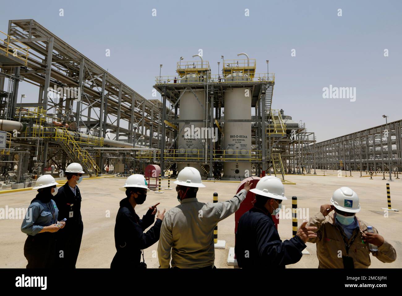 FILE - Saudi Aramco engineers and journalists look at the Hawiyah Natural  Gas Liquids Recovery Plant, which is designed to process 4.0 billion  standard cubic feet per day of sweet gas, a