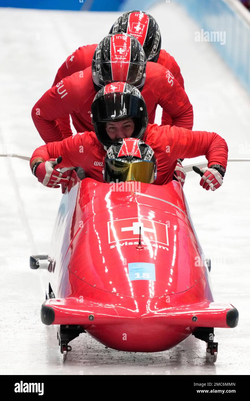 Simon Friedli of Switzerland and his team start during a 4-man bobsleigh training heat at the 2022 Winter Olympics, Wednesday, Feb