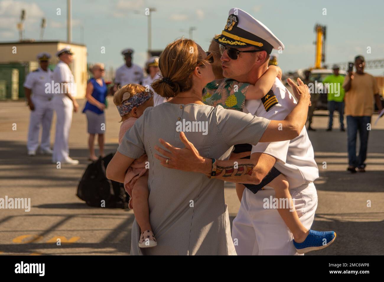 220626-N-UP745-1211  NAVAL STATION MAYPORT, Fla. (June 26, 2022) Cmdr. Robert Keller, executive officer of the Arleigh Burke-class guided-missile destroyer USS Jason Dunham (DDG 109), reunites with his family as the ship returns to Naval Station Mayport, Florida after a regularly scheduled deployment in support of maritime security operations and theater security cooperation efforts, June 26. Jason Dunham was deployed as part of the Harry S. Truman Carrier Strike Group. Stock Photo