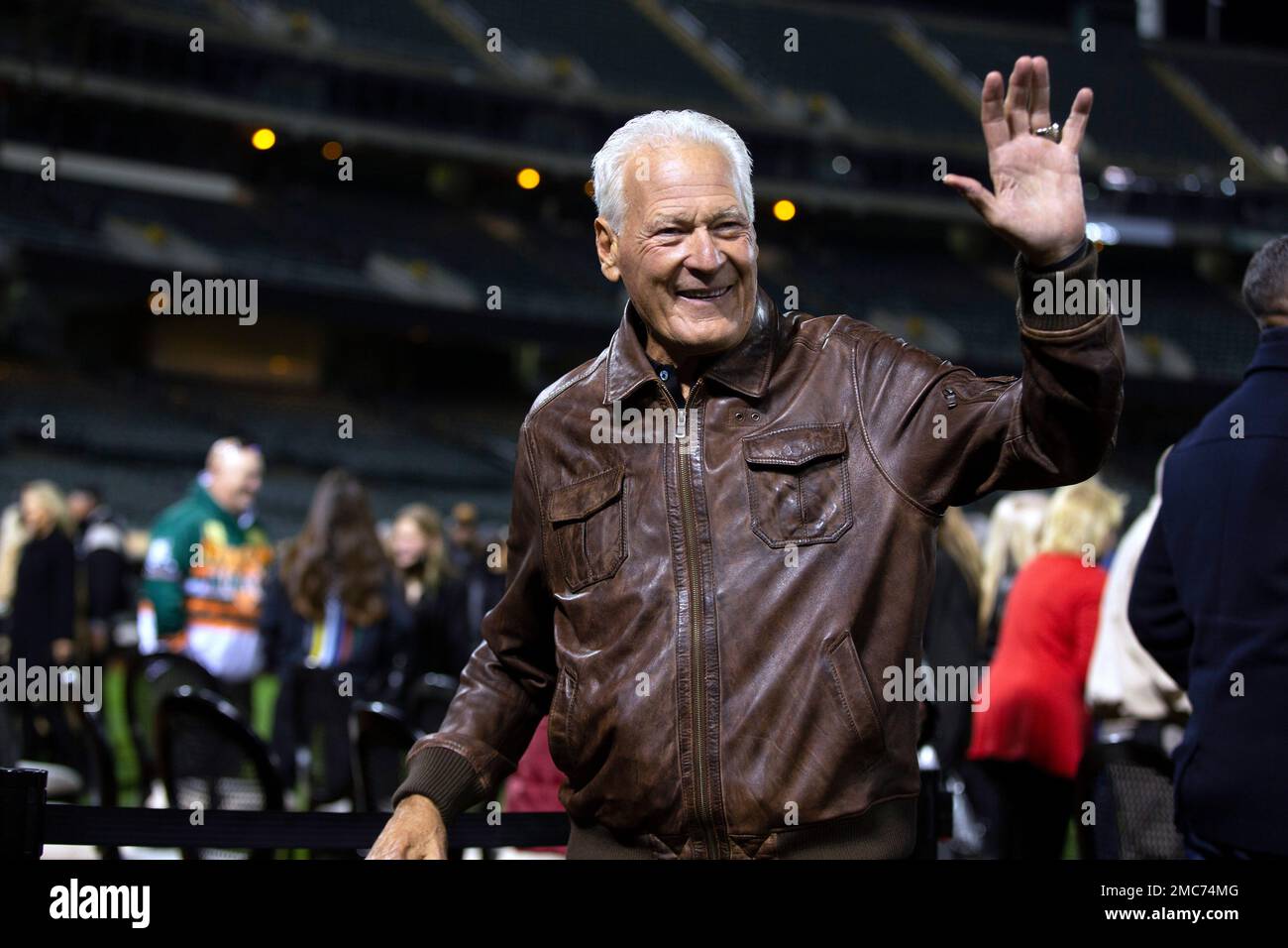 Former Oakland Raiders linebacker Phil Villapiano waves to the crowd