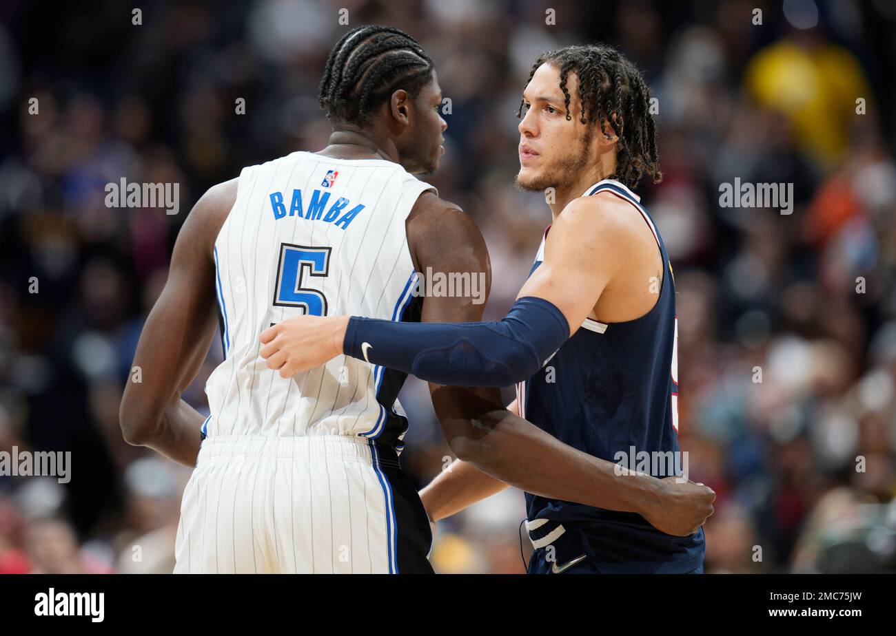 Orlando Magic center Mo Bamba, left, greets former teammate, forward Aaron Gordon, who now plays for the Denver Nuggets, in the first half of an NBA basketball game Monday, Feb