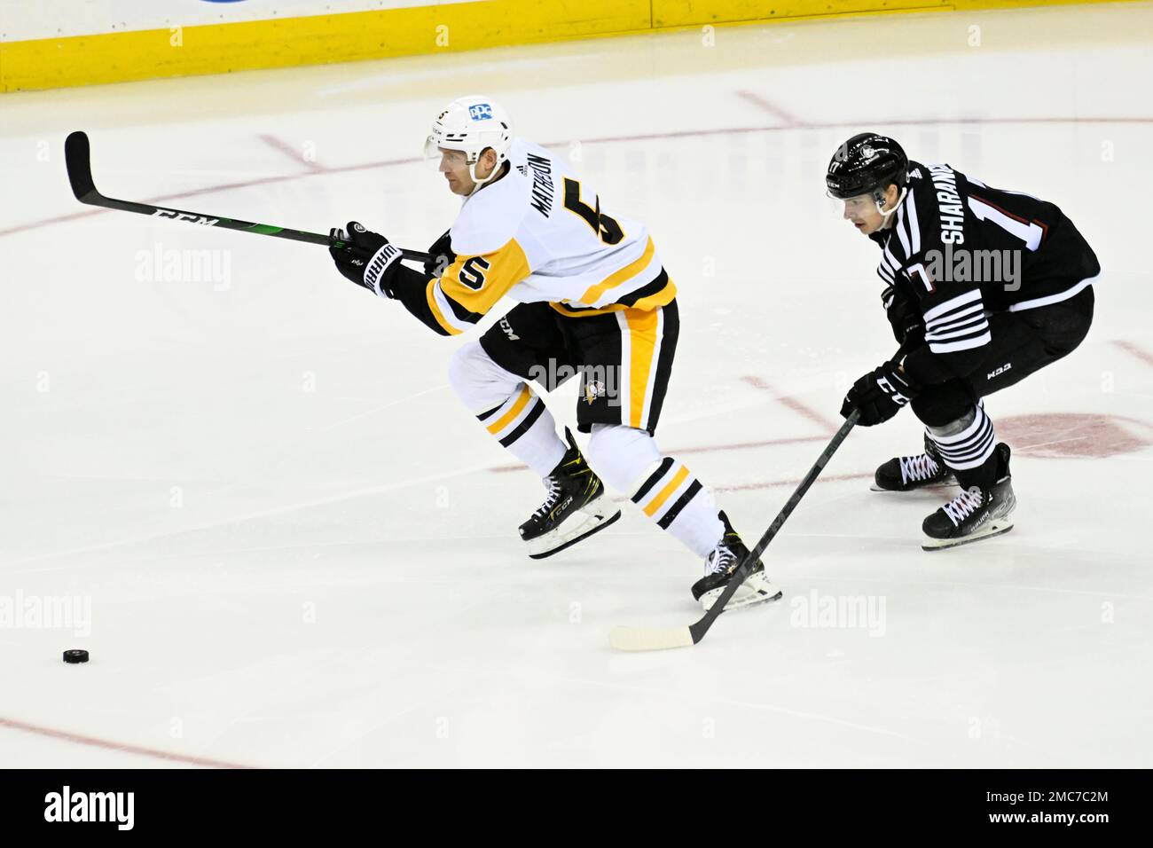 New Jersey Devils' Jack Hughes skates with the puck during the third period  of an NHL hockey game against the Pittsburgh Penguins Sunday, Feb. 13,  2022, in Newark, N.J. The Penguins defeated