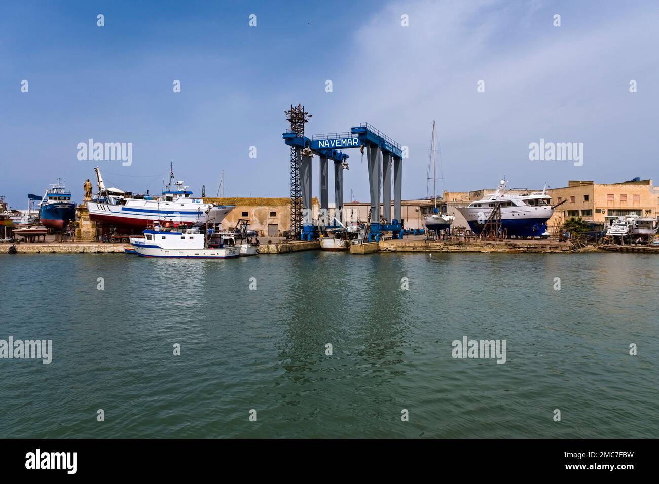 Docks, cranes and fishing boats in the harbour of Marsala, a major town in  western Sicily Stock Photo - Alamy