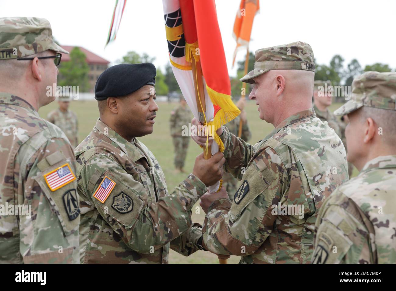 U.S. Army Command Sgt. Major Sheldon Gray(left), of the 359th Theater Tactical Signal Brigade(359th TTSB), hands off the 359th TTSB guidon to Col. Travis A. Hartman during the Change of Command Ceremony at Barton Field on Fort Gordon in Augusta, Ga on June 26, 2022. Col. Travis A. Hartman relinquished command of the 359th TTSB to Col. Tracy G. Monteith, ceremony was presided over by Major. Gen. John H. Phillips,  commanding general, 335th Signal Command Theater. Stock Photo
