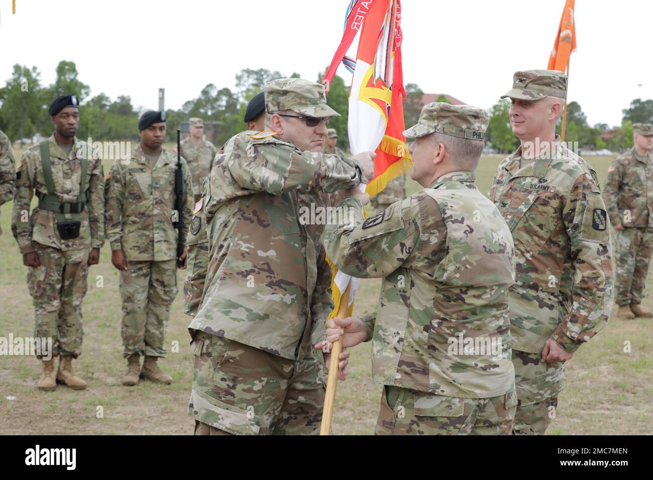 U.S. Army Major. Gen. John H. Phillips,  commanding general, 335th Signal Command Theater, passes the 359 TTSB guidon to Col. Tracy G. Monteith, incoming commander of the 359th Theater Tactical Signal Brigade, during the change of command ceremony at Barton Field on Fort Gordon in Augusta, Ga on June 26, 2022. Col. Travis A. Hartman relinquished command of the 359th TTSB to Col. Tracy G. Monteith, ceremony was presided over by Major. Gen. John H. Phillips,  commanding general, 335th Signal Command Theater. Stock Photo