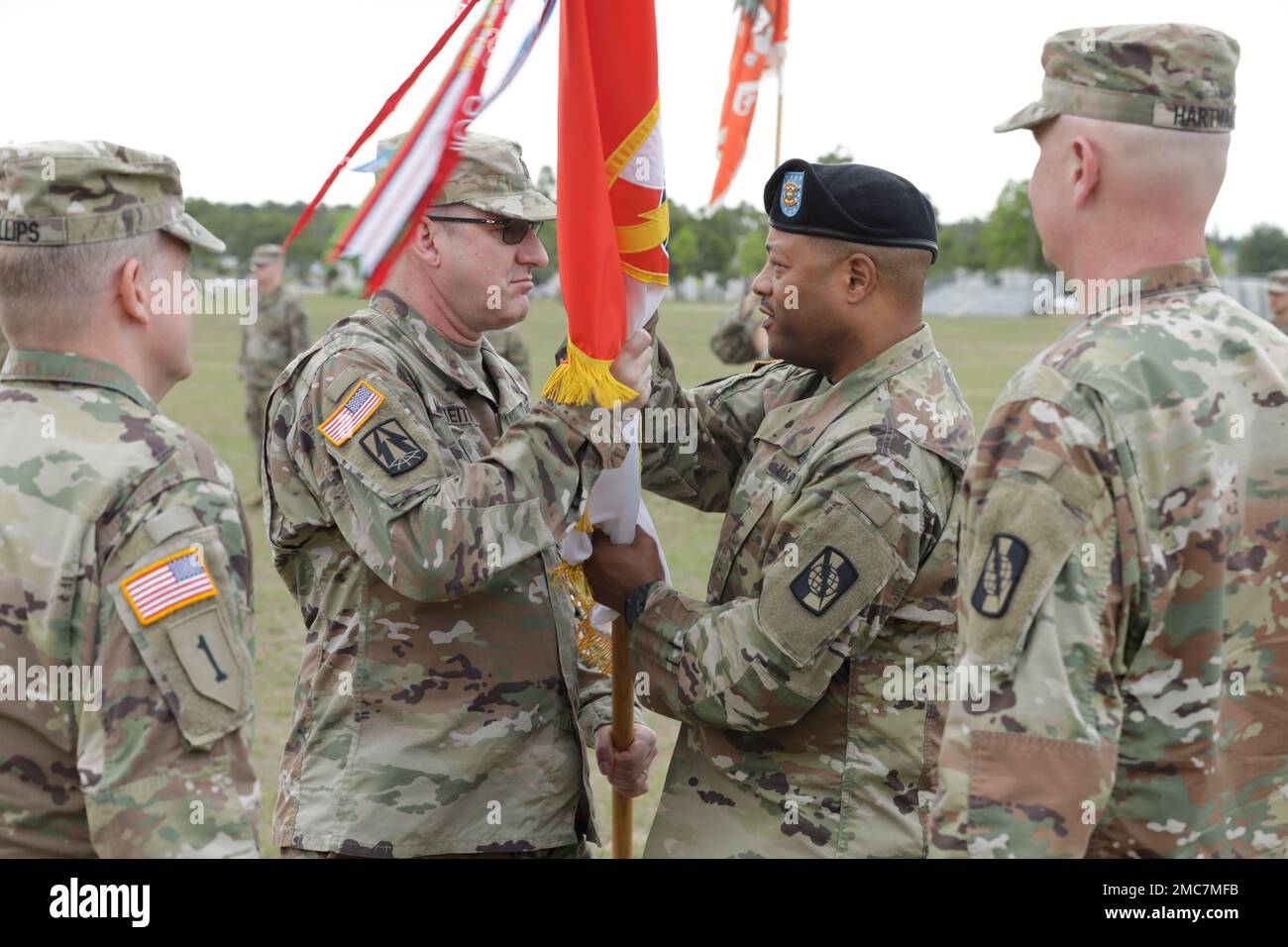 U.S. Army Tracy G. Monteith, in coming commander of the 359th Theater Tactical Signal Brigade, passes the 359th TTSB guidon back to Command Sgt. Maj. Sheldon Gray to complete the passage of command during the change of command ceremony at Barton Field on Fort Gordon in Augusta, Ga on June 26, 2022. Col. Travis A. Hartman relinquished command of the 359th TTSB to Col. Tracy G. Monteith, ceremony was presided over by Major. Gen. John H. Phillips,  commanding general, 335th Signal Command Theater. Stock Photo