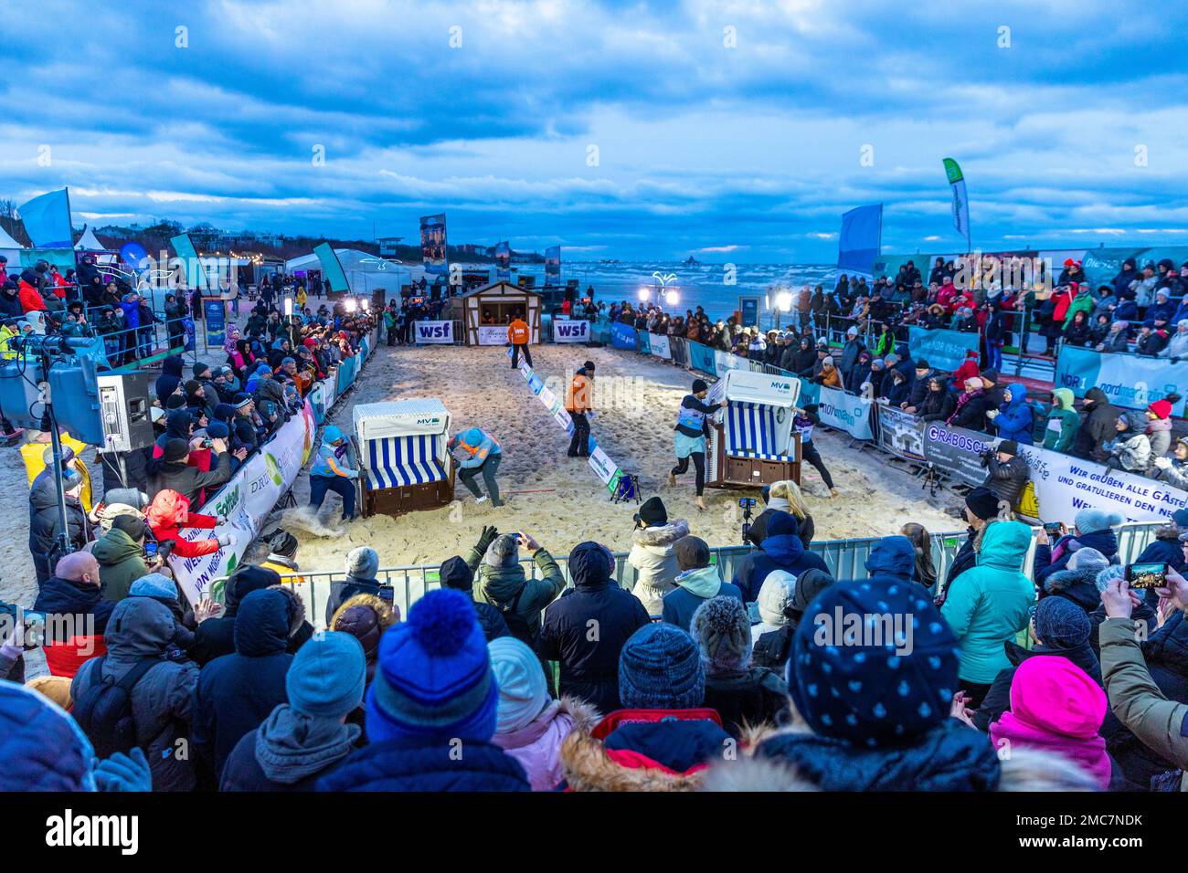Ahlbeck, Germany. 21st Jan, 2023. On the Baltic Sea beach, the participants  of the now 15th Beach Chair World Championship sprint for the best time.  Teams of two athletes each have to
