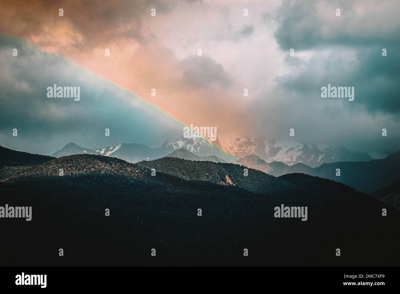 Rainbow against dark clouds hi-res stock photography and images - Alamy