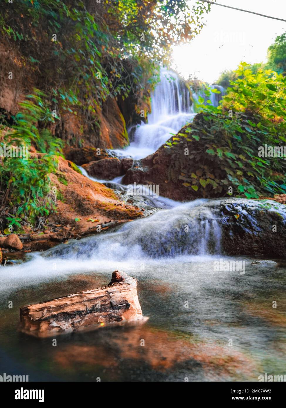 A beautiful natural view of a waterfall in the forest Stock Photo - Alamy