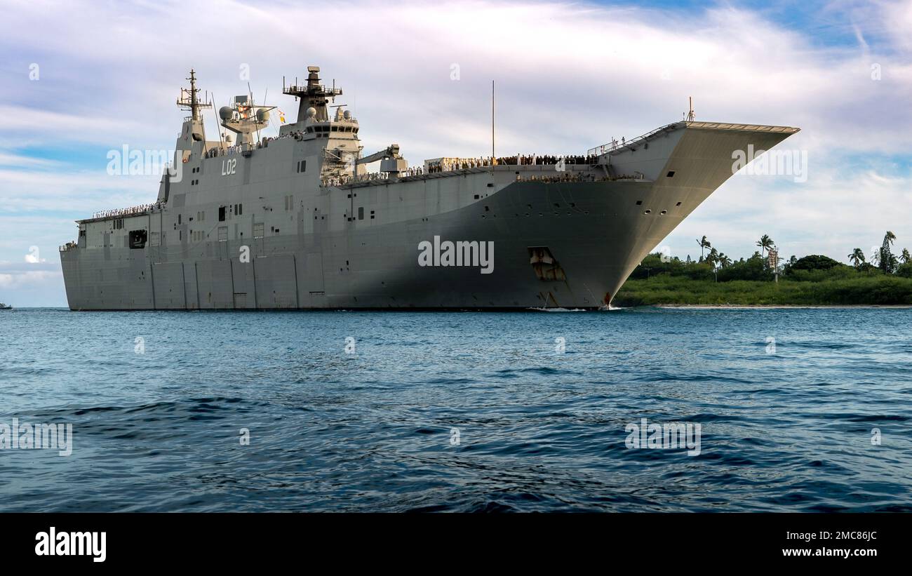 220627-N-PV401-1006 PEARL HARBOR (June 27, 2022) – Royal Australian Navy amphibious assault ship HMAS Canberra (L02) arrives at Joint Base Pearl Harbor-Hickam to participate in the Rim of the Pacific (RIMPAC) 2022. Twenty-six nations, 38 ships, four submarines, more than 170 aircraft and 25,000 personnel are participating in RIMPAC from June 29 to Aug. 4 in and around the Hawaiian Islands and Southern California. The world’s largest international maritime exercise, RIMPAC provides a unique training opportunity while fostering and sustaining cooperative relationships among participants critical Stock Photo