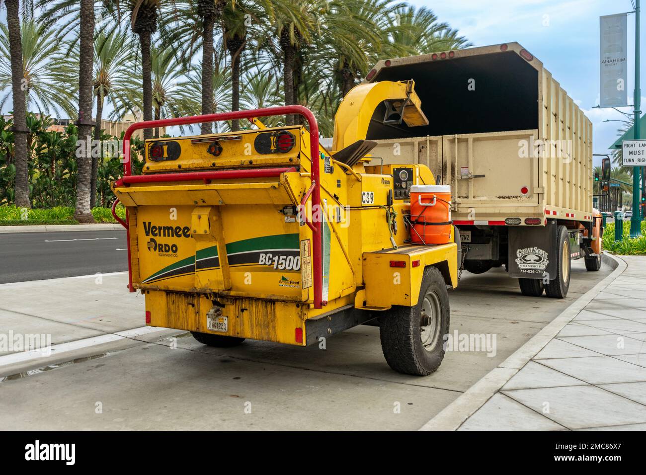 Anaheim, CA, USA – November 1, 2022: A Vermeer wood chipper trailer attached to a truck on a street in Anaheim, California. Stock Photo