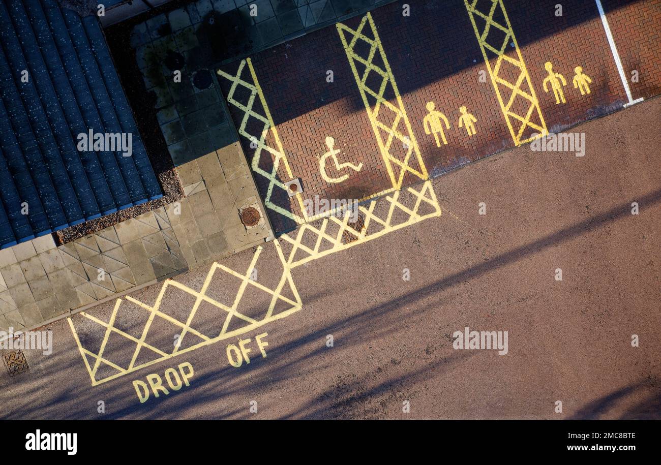 Disabled and parent, children parking spaces act school entrance Stock