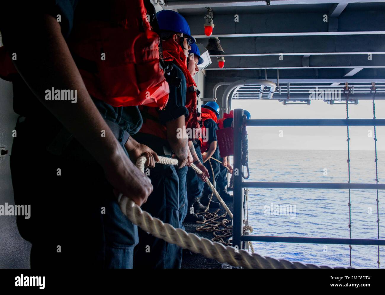 220627-N-JO823-2170 PHILIPPINE SEA (June 27, 2022) Sailors secure a line during small boat operations on the starboard davit of the U.S. Navy’s only forward-deployed aircraft carrier USS Ronald Reagan (CVN 76). Ronald Reagan, the flagship of Carrier Strike Group 5, provides a combat-ready force that protects and defends the United States, and supports alliances, partnerships and collective maritime interests in the Indo-Pacific region. Stock Photo