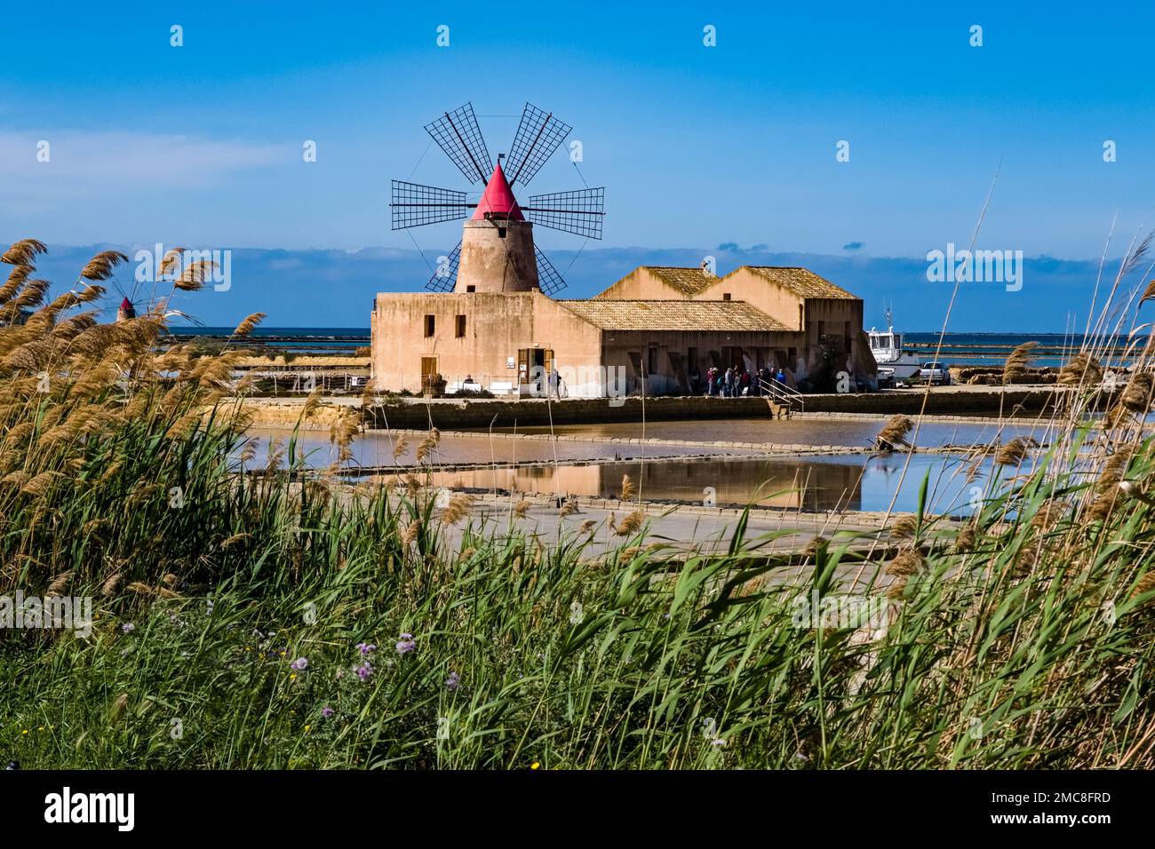Water basins, salt pans and a windmill at Mozia salt works. Stock Photo