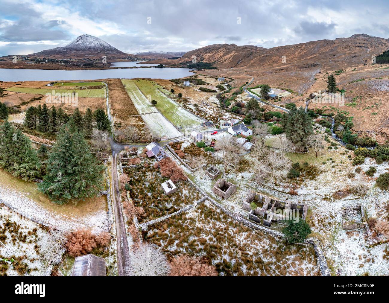 Aerial view of the Dunlewey Ghost village with the snow covered Mount Errigal in the background, County Donegal - Ireland Stock Photo