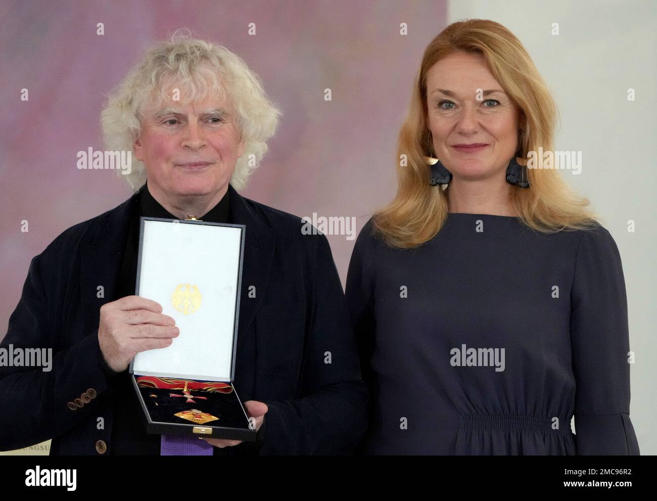 CORRECTS SPELLING OF MAGDALENA KOZENA - Conductor Simon Rattle, left, and  his wife Magdalena Kozena, right, pose for the media after Rattle received  the 'The Order of Merit of the Federal Republic