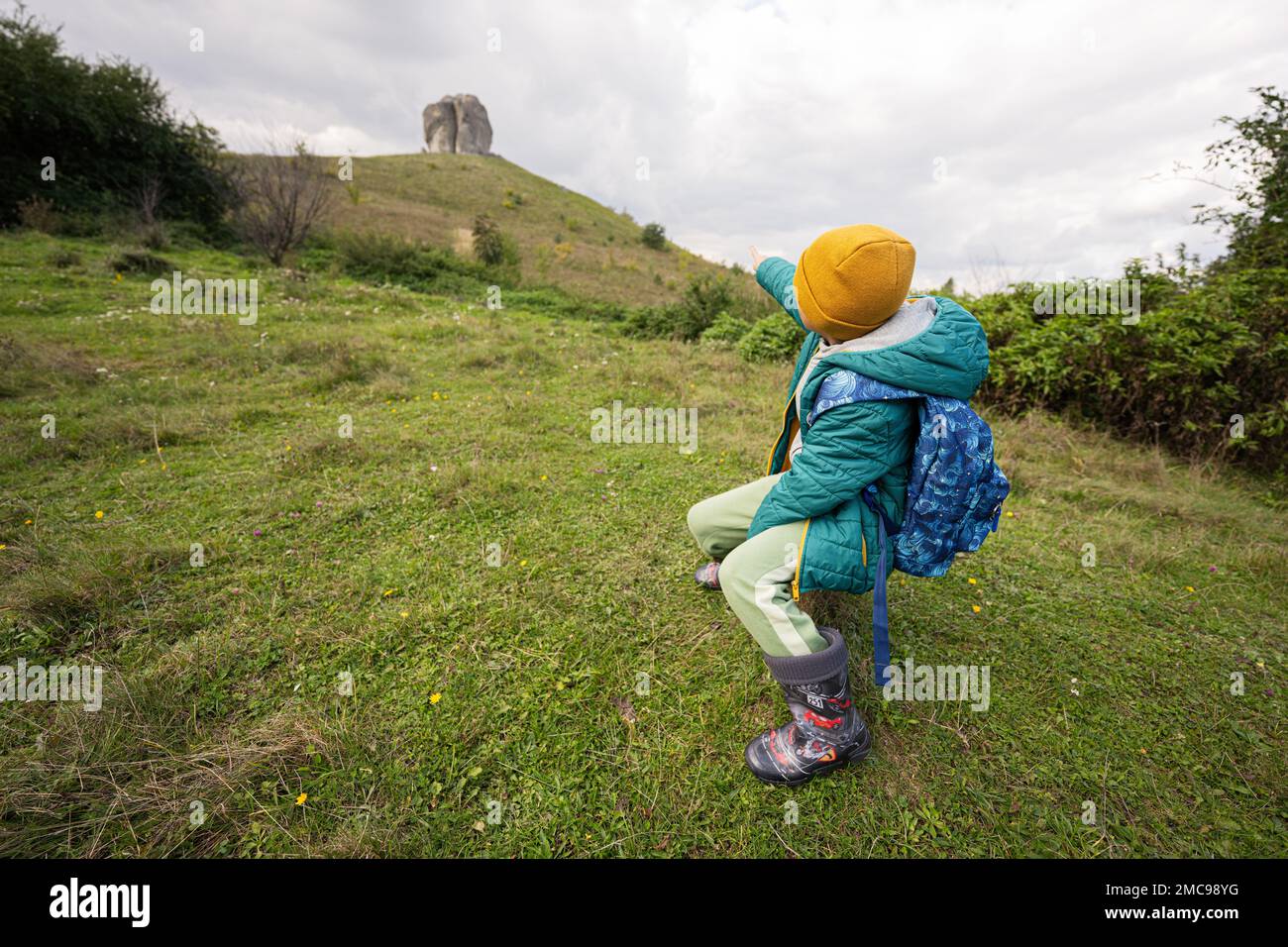 Activity on sunny autumn day, boy exploring nature. Kid wear yellow hat ...
