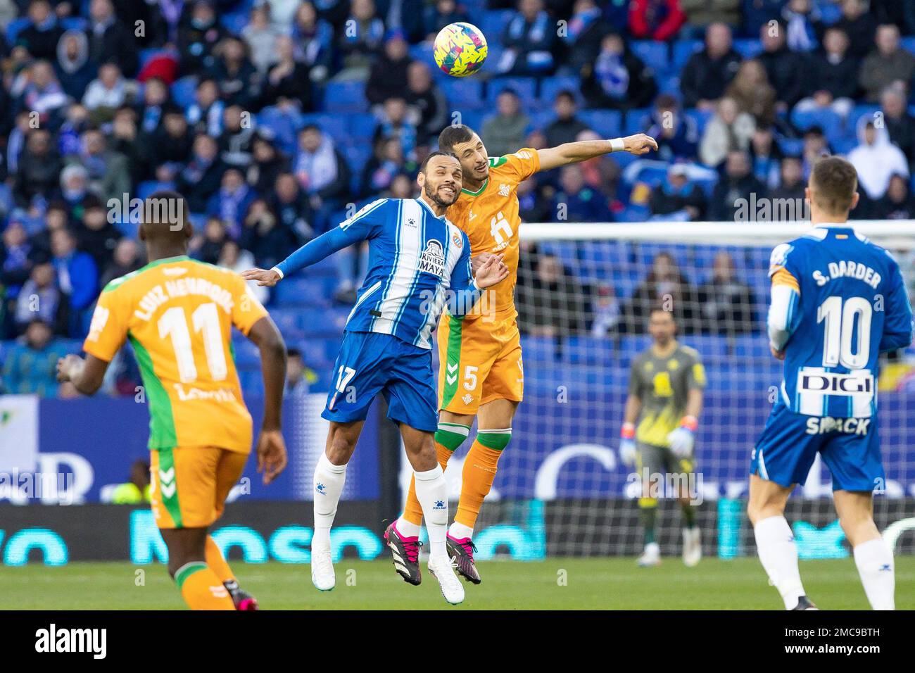 Martin Braithwaite of RCD Espanyol in action with Guido Rodriguez of Real Betis Balompie during the Liga match between RCD Espanyol and Real Betis at RCDE Stadium in Cornella, Spain. Stock Photo
