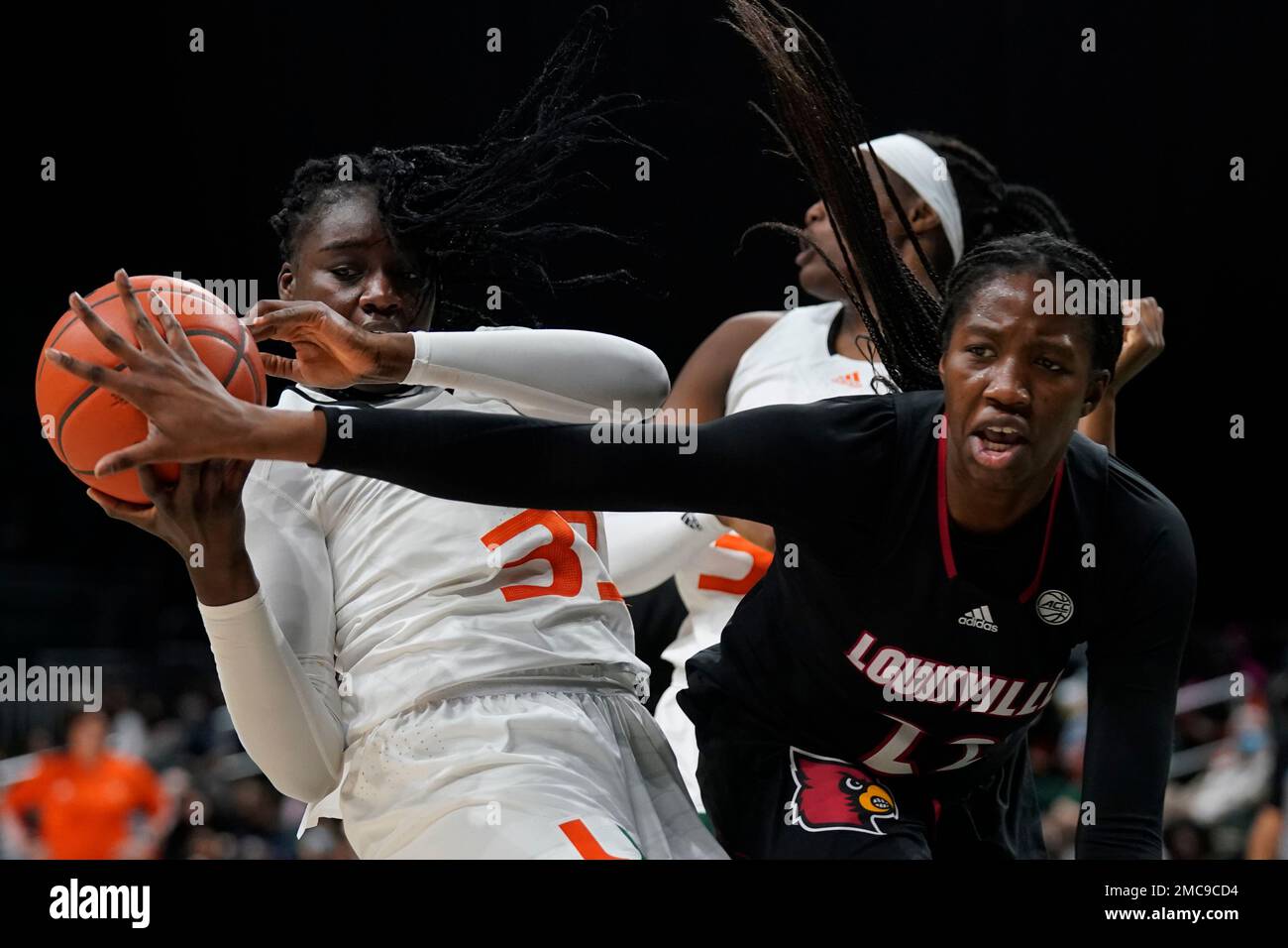 Louisville forward Liz Dixon, right, attempts to swat the ball away ...