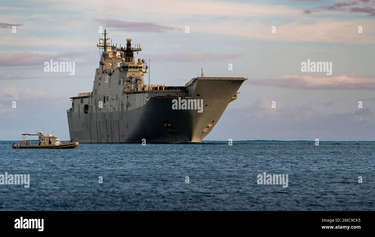 220627-N-PV401-1004 PEARL HARBOR (June 27, 2022) – Royal Australian Navy amphibious assault ship HMAS Canberra (L02) arrives at Joint Base Pearl Harbor-Hickam to participate in the 2022 Rim of the Pacific (RIMPAC) exercise. Twenty-six nations, 38 ships, four submarines, more than 170 aircraft and 25,000 personnel are participating in RIMPAC from June 29 to Aug. 4 in and around the Hawaiian Islands and Southern California. The world’s largest international maritime exercise, RIMPAC provides a unique training opportunity while fostering and sustaining cooperative relationships among participants Stock Photo