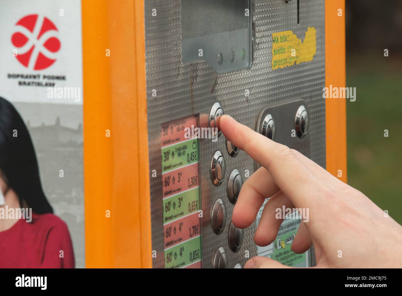 Nitra, Slovakia - 01.07.2023: A woman's hand buys a ticket in a ticket machine. Stock Photo