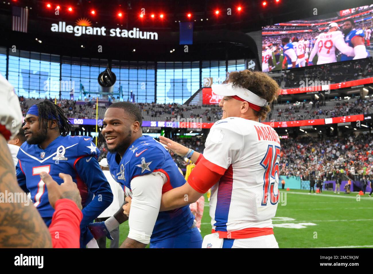 AFC quarterback Patrick Mahomes, right, of the Kansas City Chiefs, greets  NFC inside linebacker Micah Parsons, center, of the Dallas Cowboys, after  the Pro Bowl NFL football game at Allegiant Stadium, Sunday,