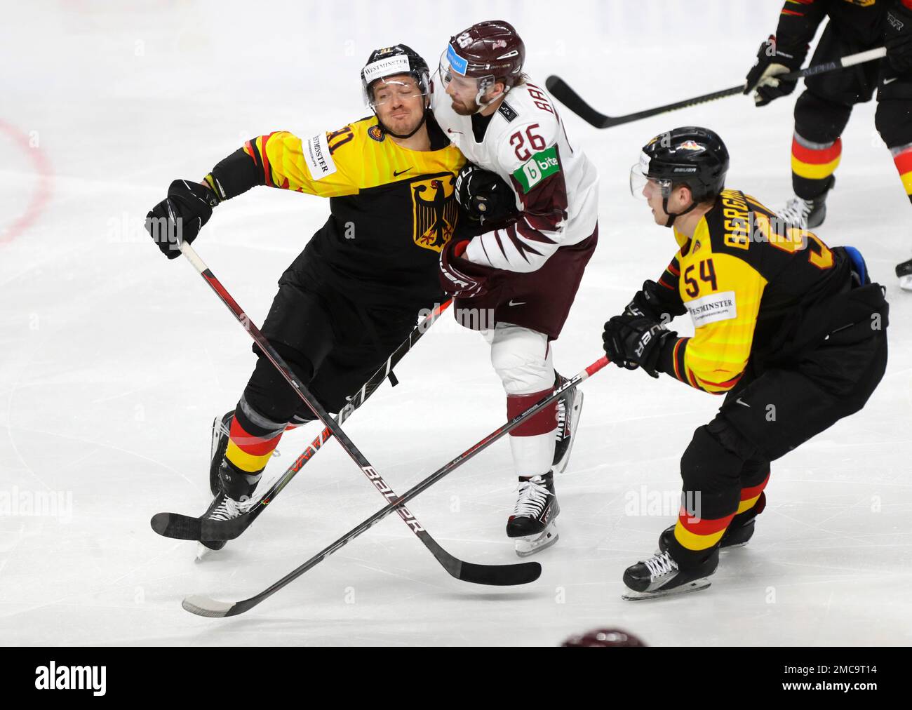 FILE- Germanys Moritz Muller, left, challenges for the puck with Latvias Uvis Balinskis (26) during the Ice Hockey World Championship group B match between Germany and Latvia at the Arena in Riga,