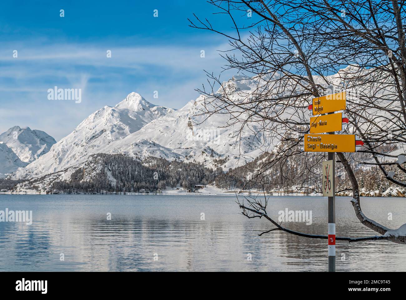 Hiking signpost in a winter landscape at Lake Sils, Engadine, Switzerland Stock Photo