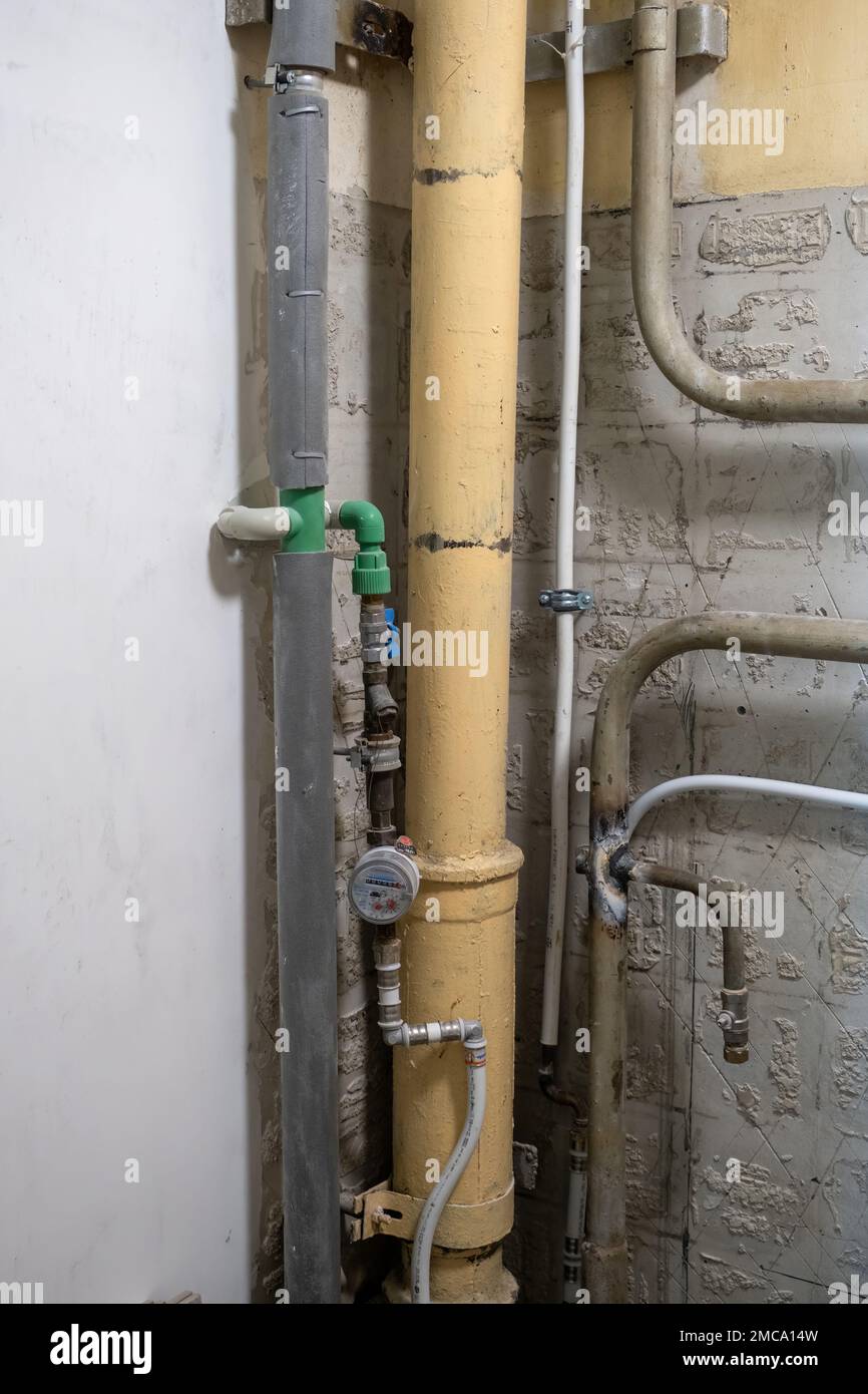 Plumbing system in old premises. Water drainage circuit, Plumbing problems, Works related to leaking faucet, Dark tone, Selective focus. Stock Photo