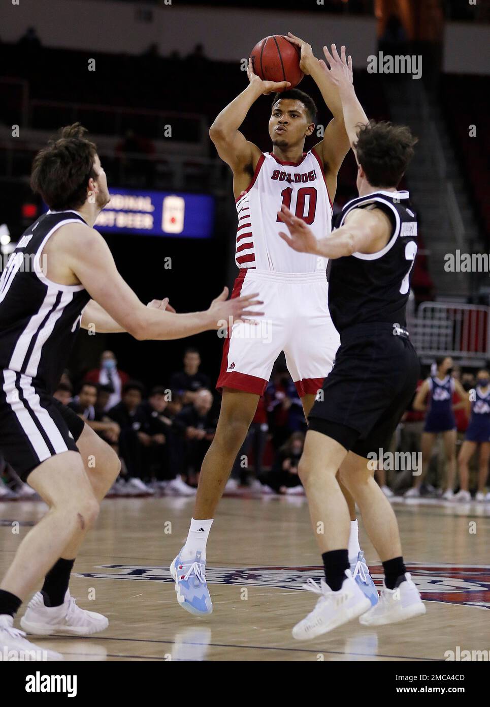 Fresno State's Orlando Robinson shoots against Nevada defenders, including  Alem Huseinovic, right, during the second half of an NCAA college basketball  game in Fresno, Calif., Friday, Feb. 4, 2022. (AP Photo/Gary Kazanjian