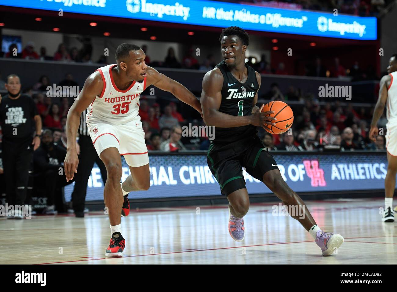 Tulane guard Sion James (1) drives to the basket against Houston forward Fabian White Jr. (35