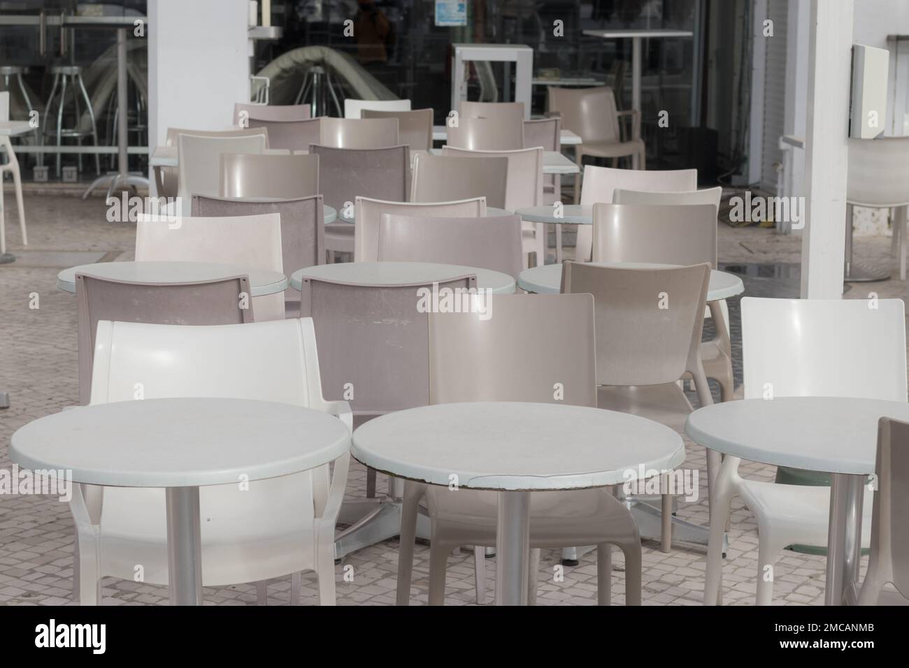 Interior of a cafe, restaurant, bistro, cafeteria in the modern city. Empty tables in an outdoor cafe. No customers in the cafe. Stock Photo