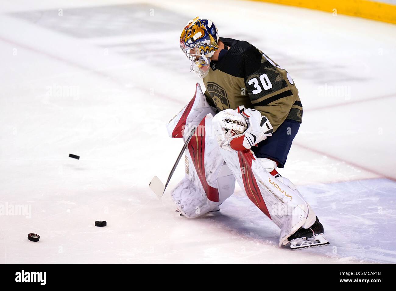 Florida Panthers goaltender Spencer Knight (30) wears a military-themed  uniform for Military Appreciation night during warm ups before an NHL  hockey game against the Vegas Golden Knights, Thursday, Jan. 27, 2022, in