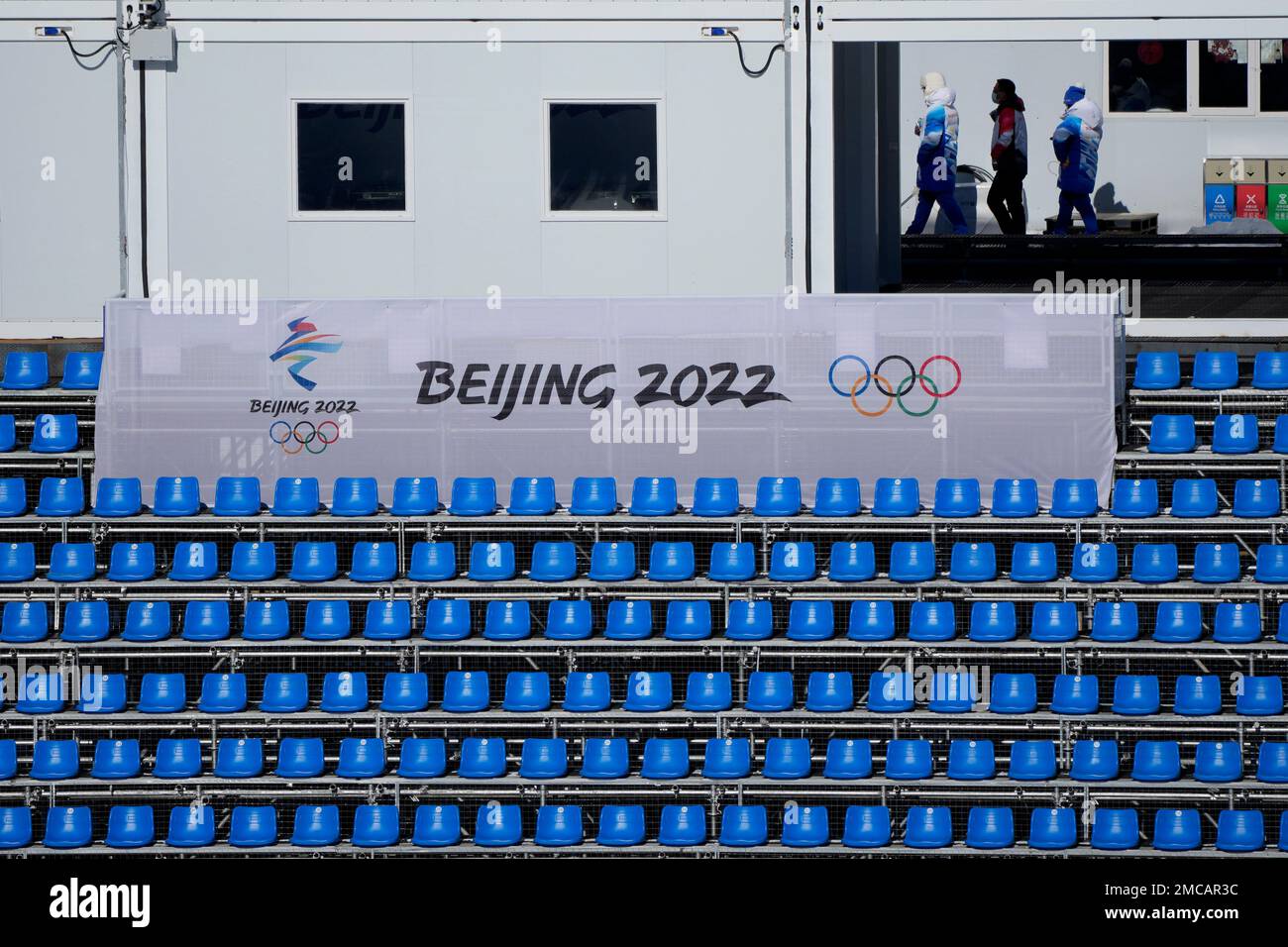 Workers walk through the stands at the National Cross-Country Skiing ...