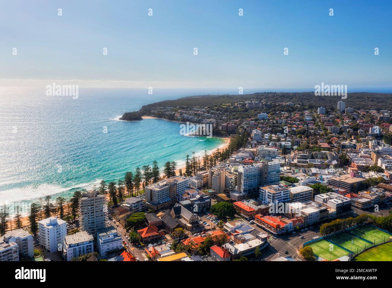 Famous Manly beach waterfront with surf and beachgoers in Sydney Northern beaches North Shore in aerial landscape. Stock Photo