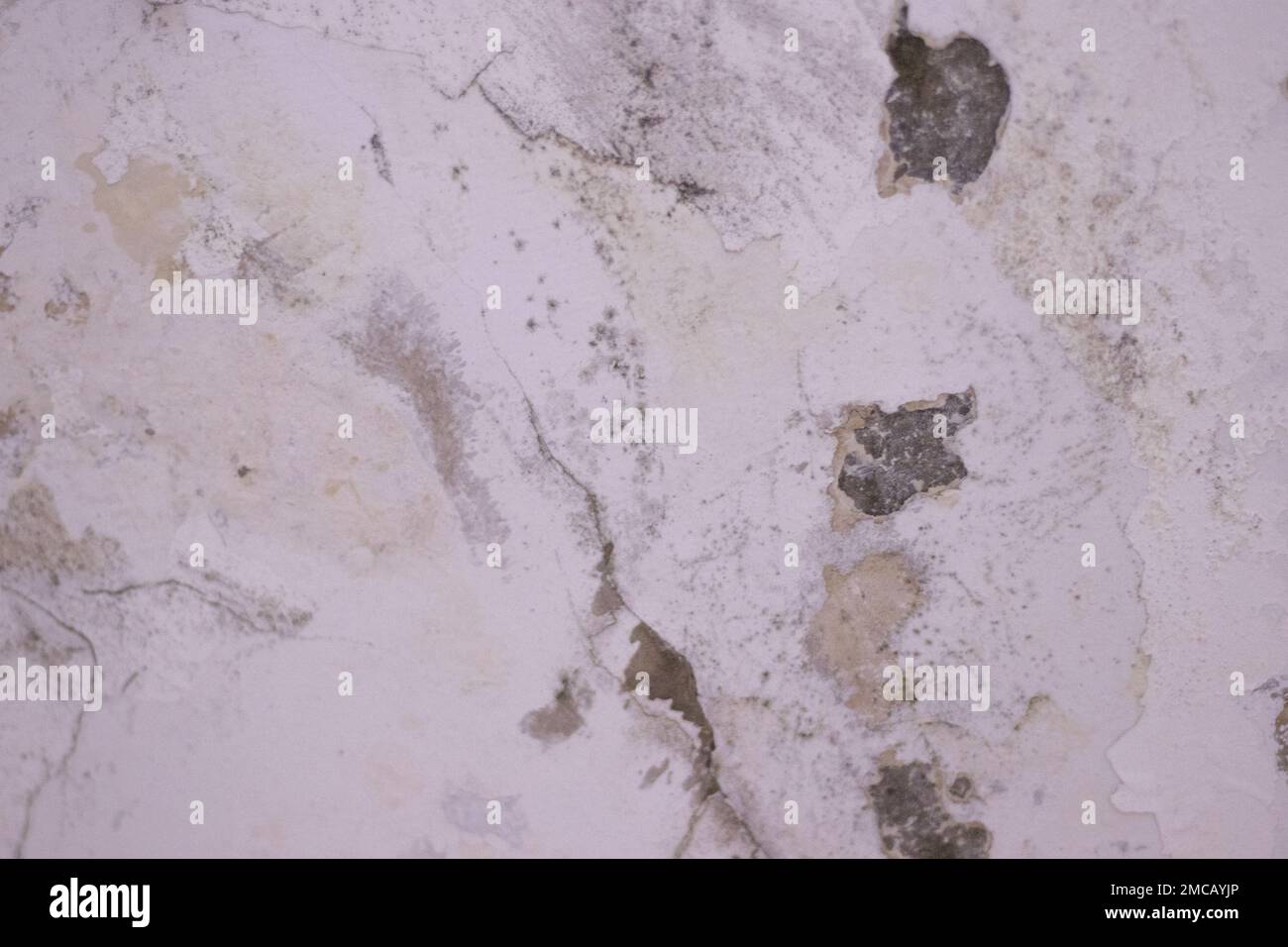 Water leaks onto the wall, causing damage and peeling paint. The