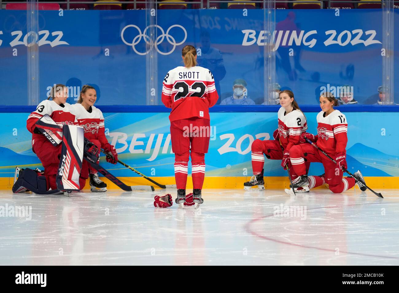 Players of Denmark's women's ice hockey team pose for photo at the 2022