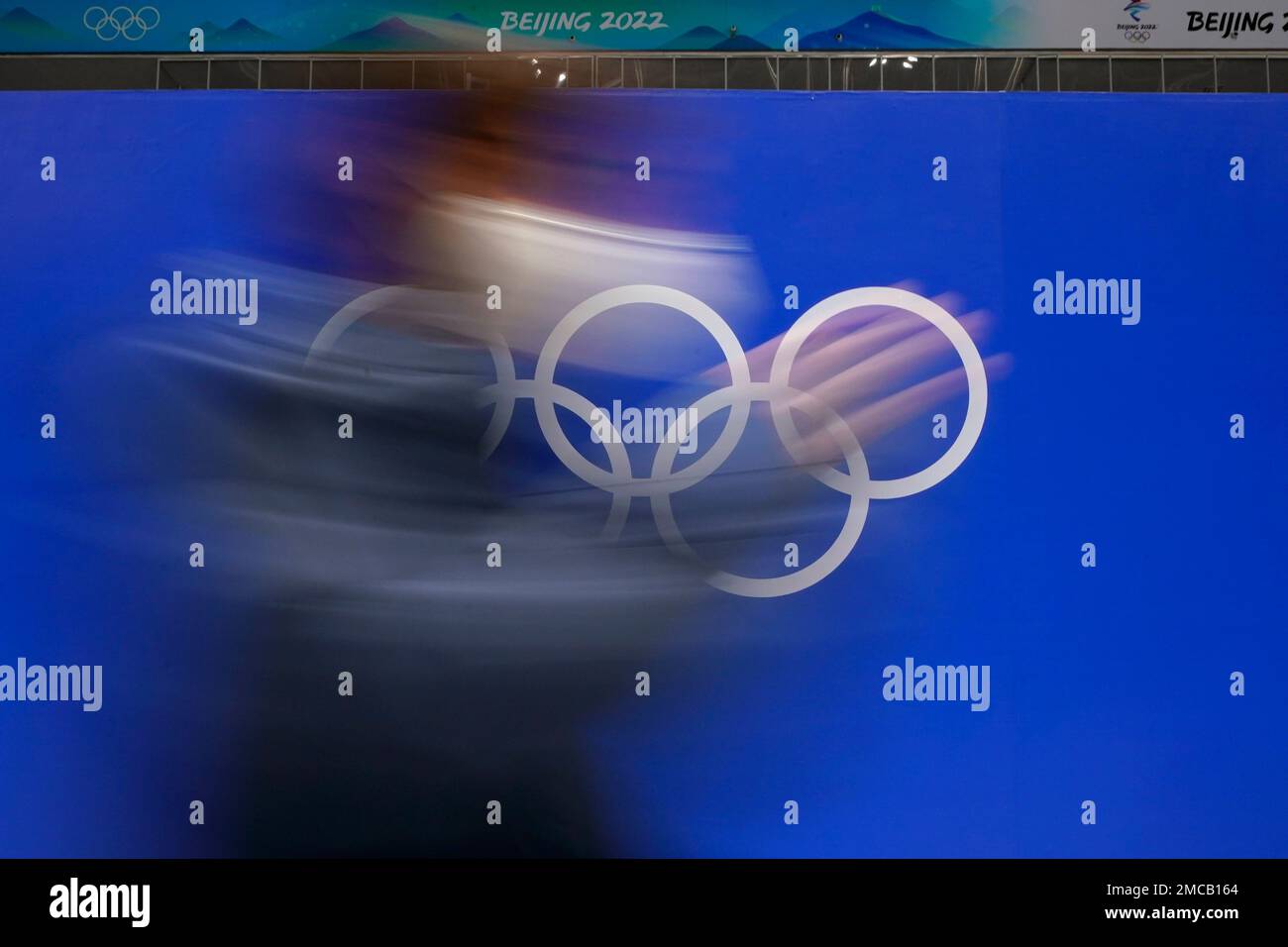 A person walks past the Olympic rings at the National Indoor Stadium at ...