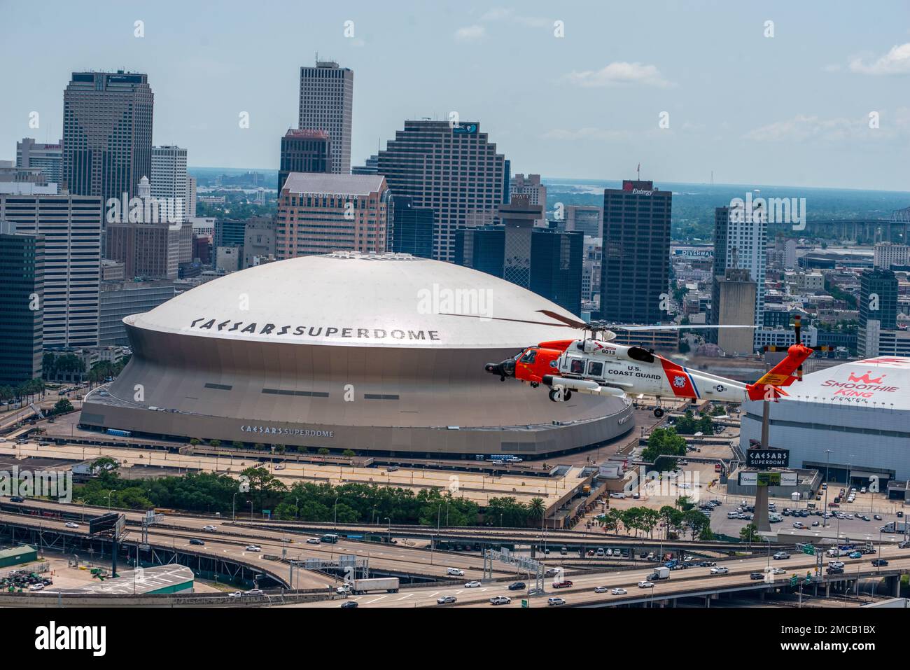 Air Station New Orleans MH-60 helicopter flies past the superdome following a formation flight June 28, 2022 in New Orleans, LA.  The MH-60 helicopters will be replacing the MH-65’s at Air Station New Orleans after a transitional period. Stock Photo