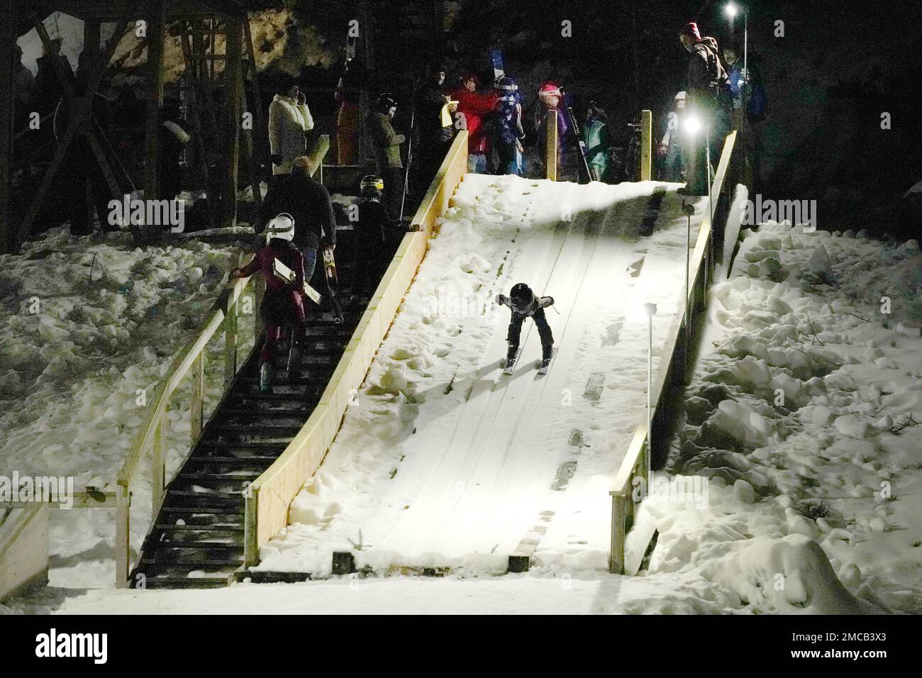 Julia Lindquist, 4, heads down the 5-meter ski jump Tuesday, Jan. 18, 2022,  at the Norge Ski Club in Fox River Grove, Ill. Lindquist was drawn to the  sport when her parents