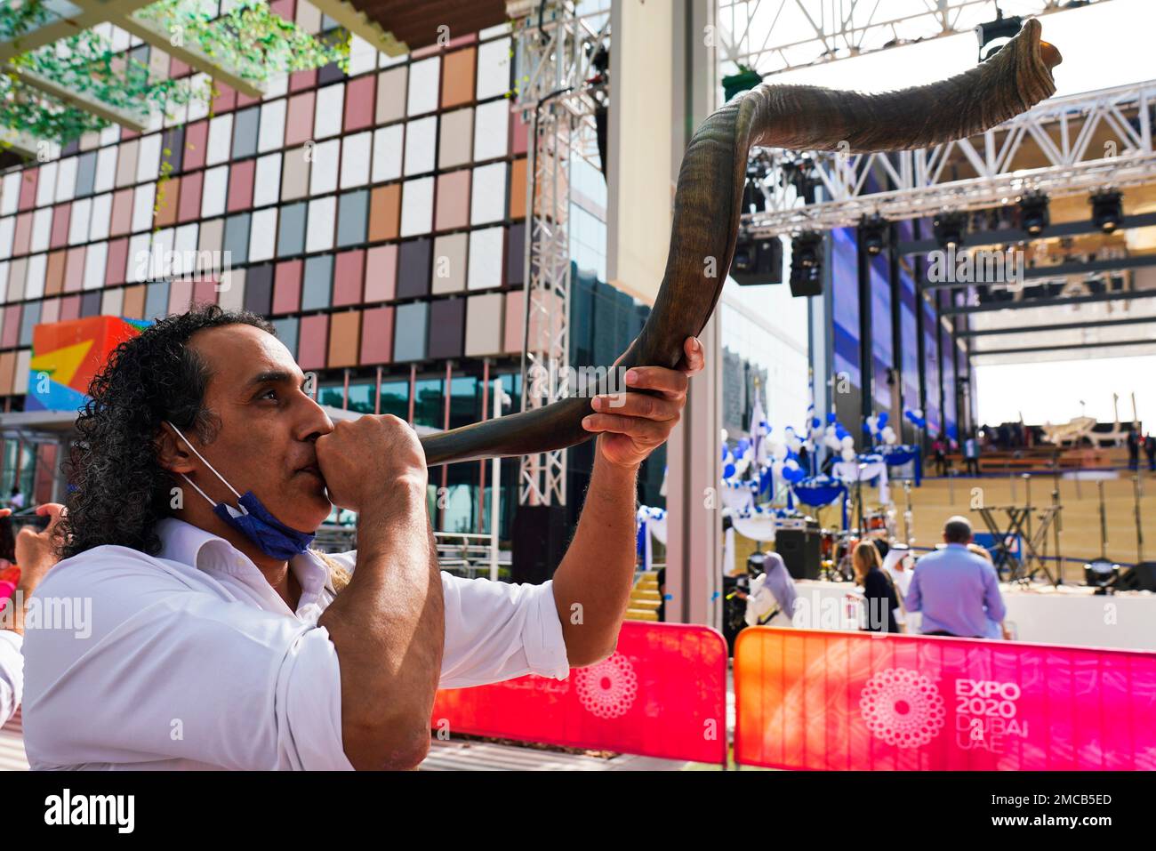 A man blows a shofar, a musical instrument made from an animal horn