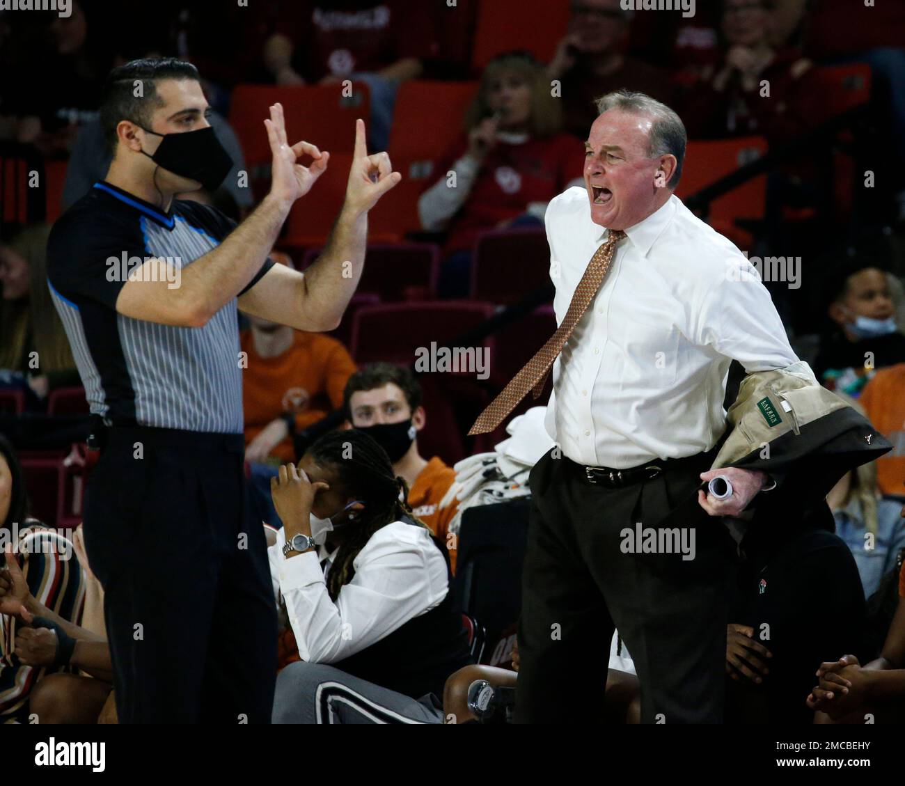 Texas head coach Vic Schaefer removes his jacket while yelling at game ...