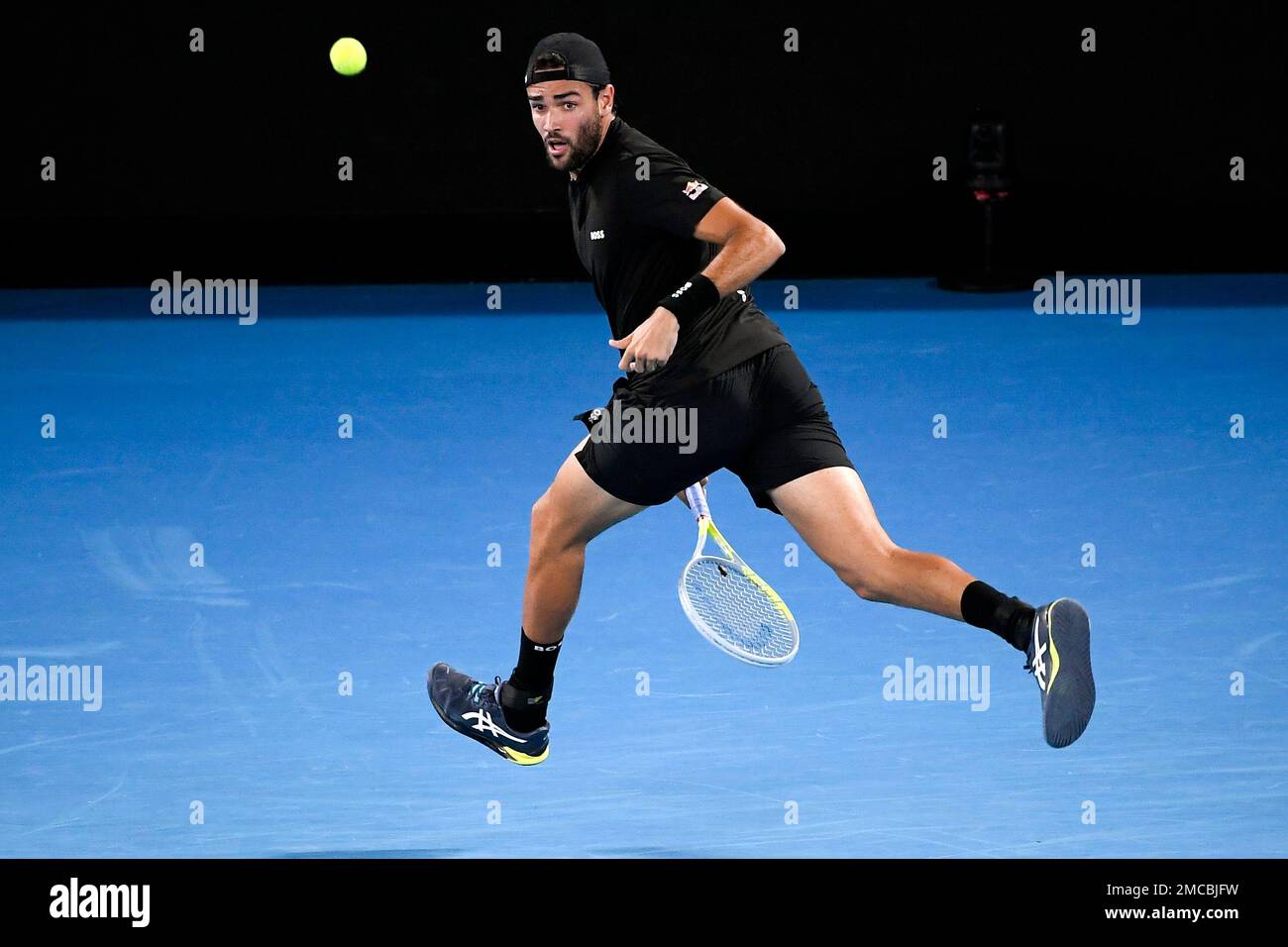 Matteo Berrettini of Italy plays a shot between his legs to Gael Monfils of France during their quarterfinal match at the Australian Open tennis championships in Melbourne, Australia, Tuesday, Jan