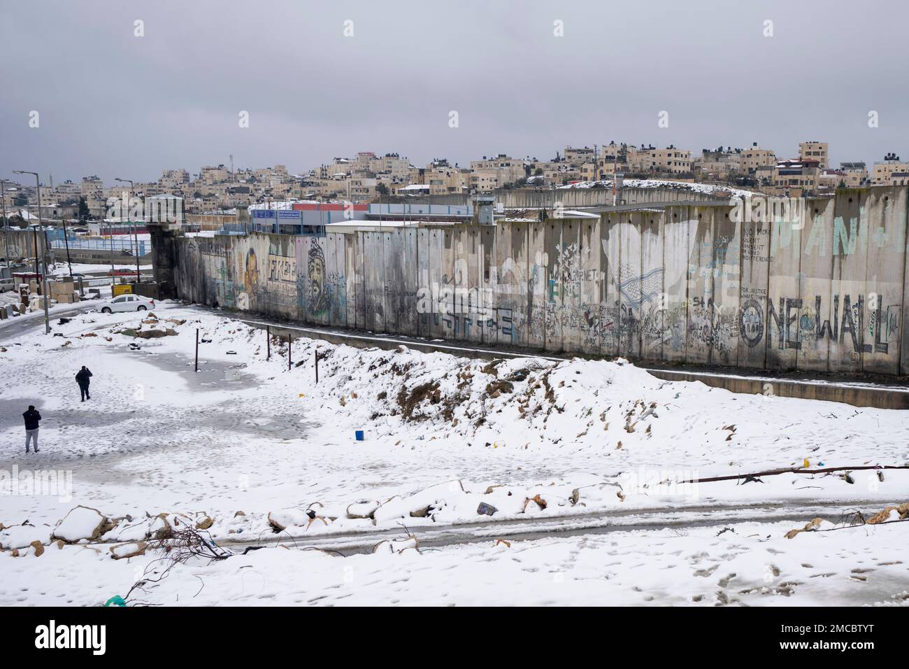 Snow surrounds a section of Israel's separation barrier, near the