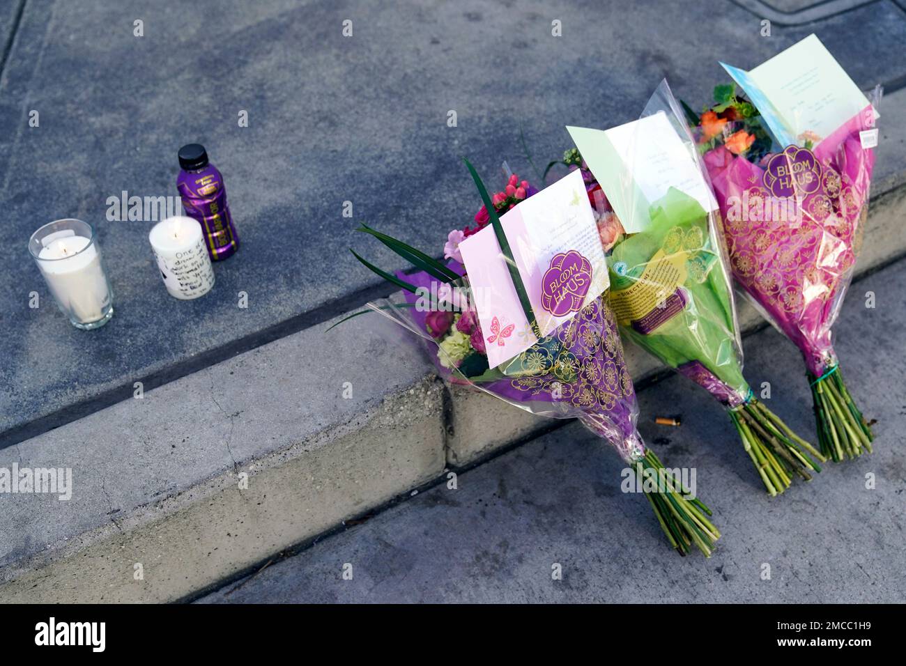 Flowers and candles left by fans lay on the ground outside Crypto.com Arena  to honor former Los Angeles Lakers NBA basketball player Kobe Bryant and  his daughter, Gianna, on Wednesday, Jan. 26,
